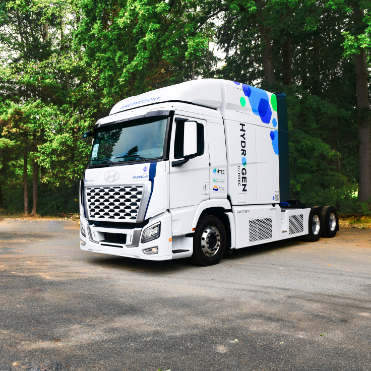 HTEC's Hydrogen Fuel Cell Electric Truck in front of trees